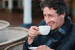 Attractive man drinking coffee smiling enjoying beverage at restaurant cafe