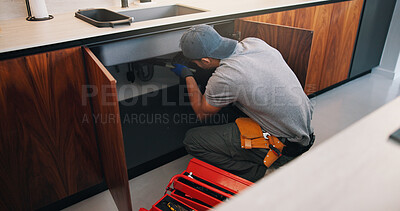 Buy stock photo Plumber, man and maintenance on kitchen sink with tools, pipe repair and check for quality assurance. Handyman, person and plumbing work in home with equipment, fix leak and inspection from back.