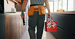 Plumber, man and hands in kitchen with toolbox, maintenance job or repair skills for renovation project. Handyman, person and technician walk in home with diy equipment, plumbing service and back.