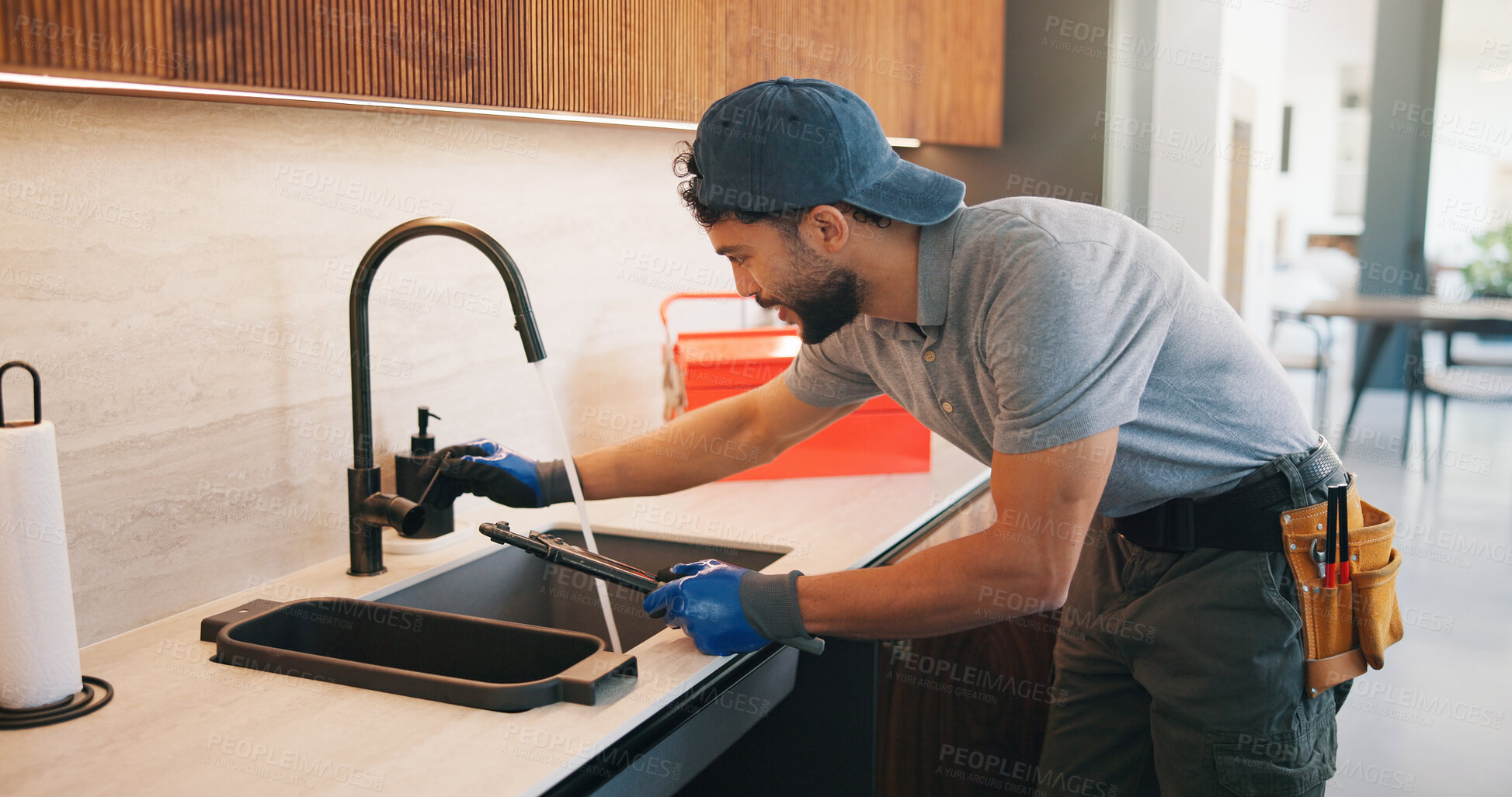 Buy stock photo Repair, check or plumber in kitchen with tools, tap testing or sewer review in system maintenance. Inspection, servicing or handyman with water, faucet installation or restoration in home improvement