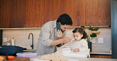 Buy stock photo Phone call, father and feeding child in kitchen, multitask and communication for nutrition in morning. Mobile chat, dad and toddler eating breakfast at home, health and growth with single parent