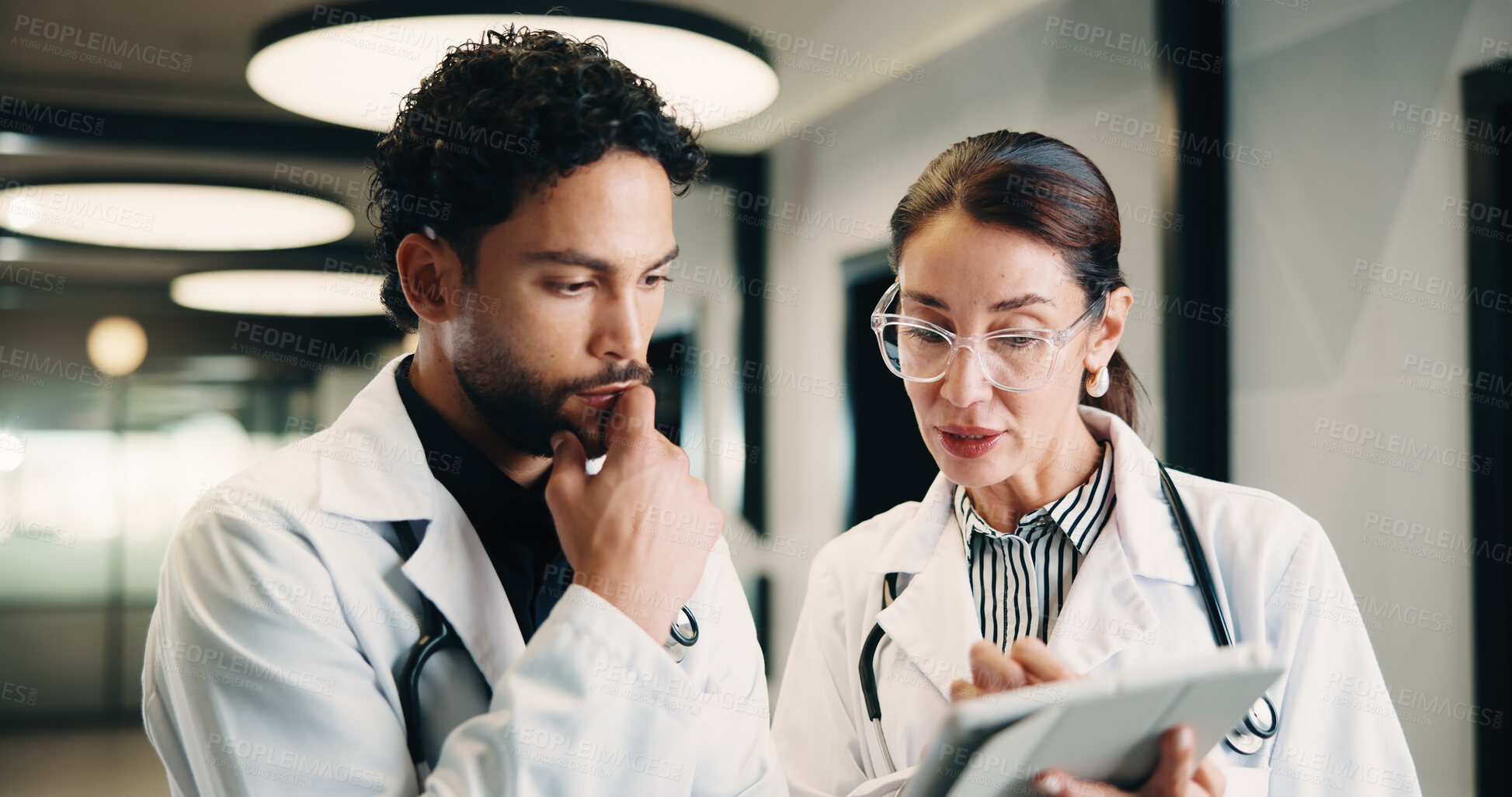 Buy stock photo Medical, tablet and team of doctors thinking for advice, problem solving or healthcare solution. Hospital, tech and people with planning, digital results or decision for treatment in clinic hallway