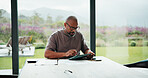 Mature, man and typing in home with tablet, financial planning and online website for utility bills. Black person, glasses and reading at table with tech, research and budget for household expenses.