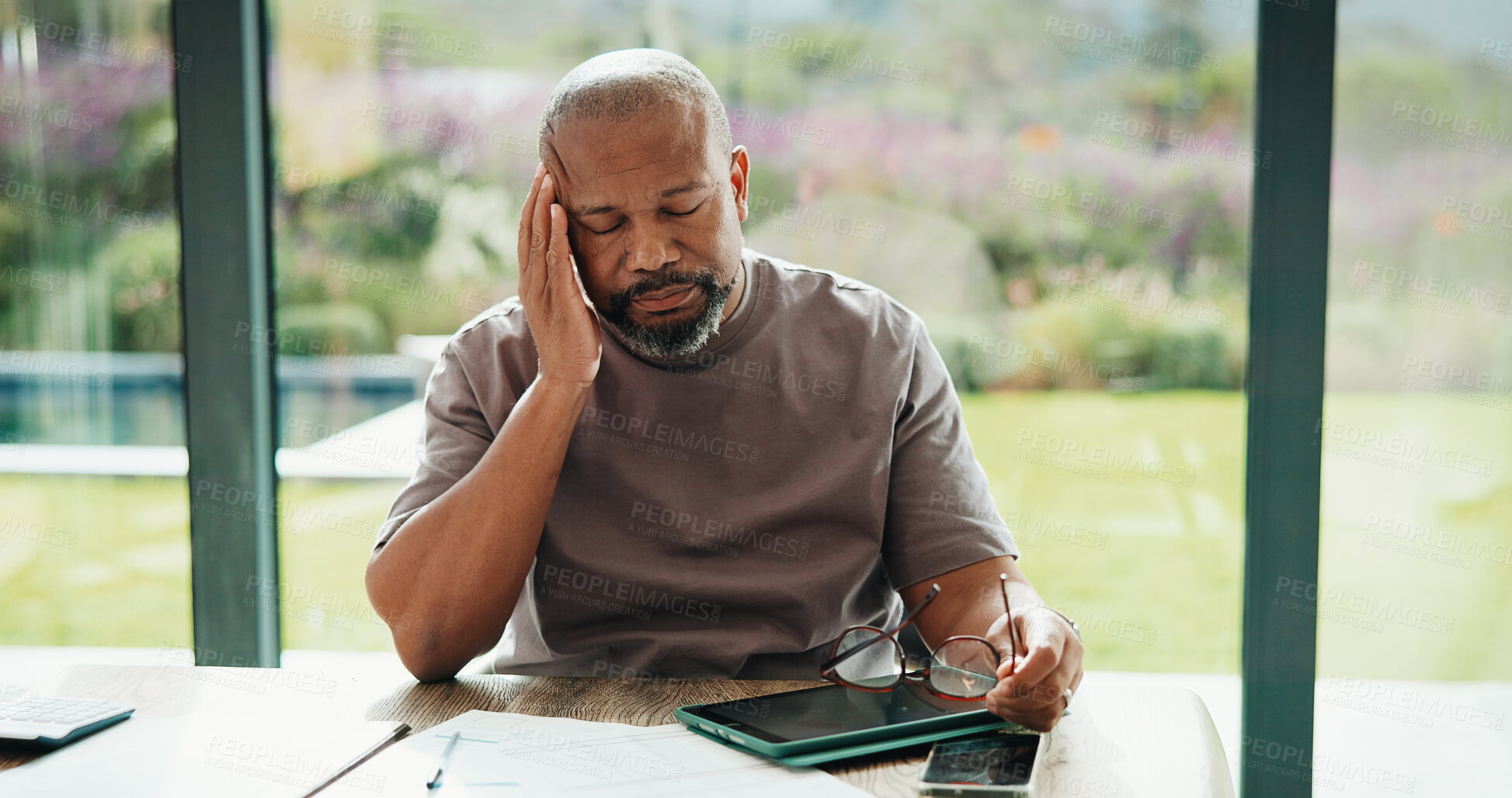 Buy stock photo Finance, man and glasses with headache in home for debt overload, budget stress or inflation. Mature black person, eyewear and migraine for financial anxiety, missed bills or overwhelmed for expenses