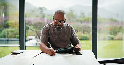 Buy stock photo Bills, paperwork and black man on tablet in home for finance review, online payment and expenses. Documents, writing and mature person on tech for digital banking, budget planning or financial report