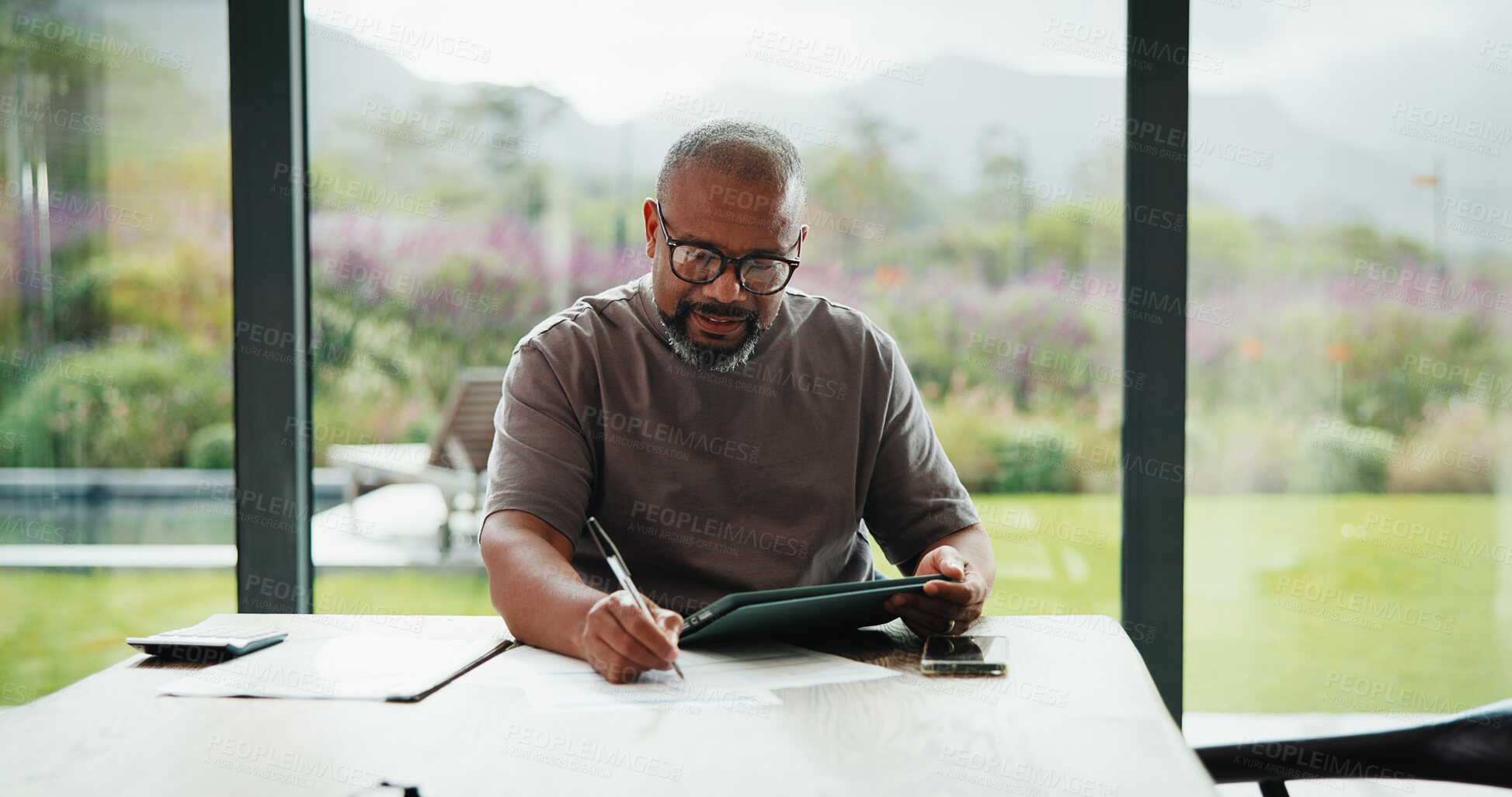 Buy stock photo Bills, paperwork and black man on tablet in home for finance review, online payment and expenses. Documents, writing and mature person on tech for digital banking, budget planning or financial report