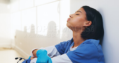Buy stock photo Tired, nurse and worry with woman in hospital for medical burnout, stress and thinking. Healthcare mistake, reflection and challenge with frustrated person on floor of clinic for fatigue and grief