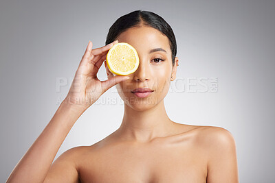 Buy stock photo Portrait, woman and skincare in studio with lemon, antioxidants and vitamin C benefits for wellness. Female person, fruit or natural cosmetics for self care, beauty or dermatology on white background
