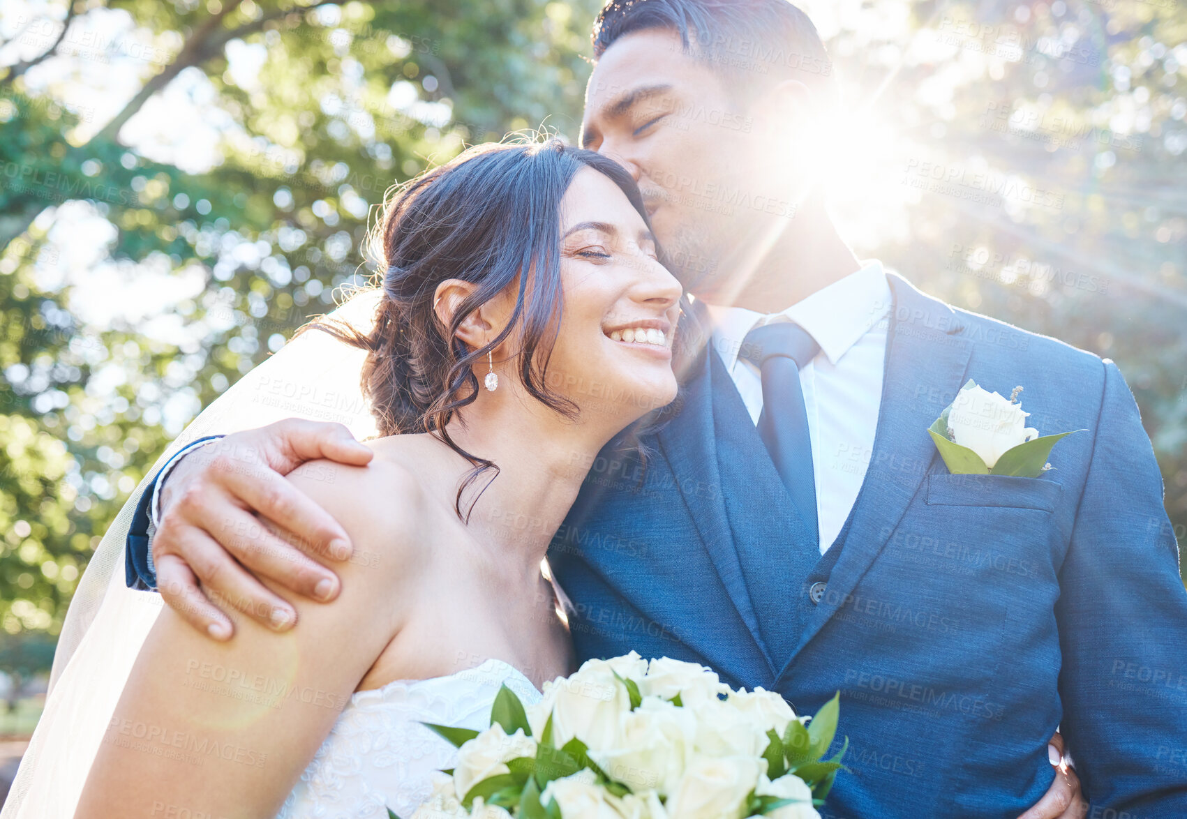 Buy stock photo Wedding, couple and kiss with bouquet at park for commitment, flare and relationship vow. People, groom and bride with affection in nature for marriage ceremony, celebration hug and bonding together