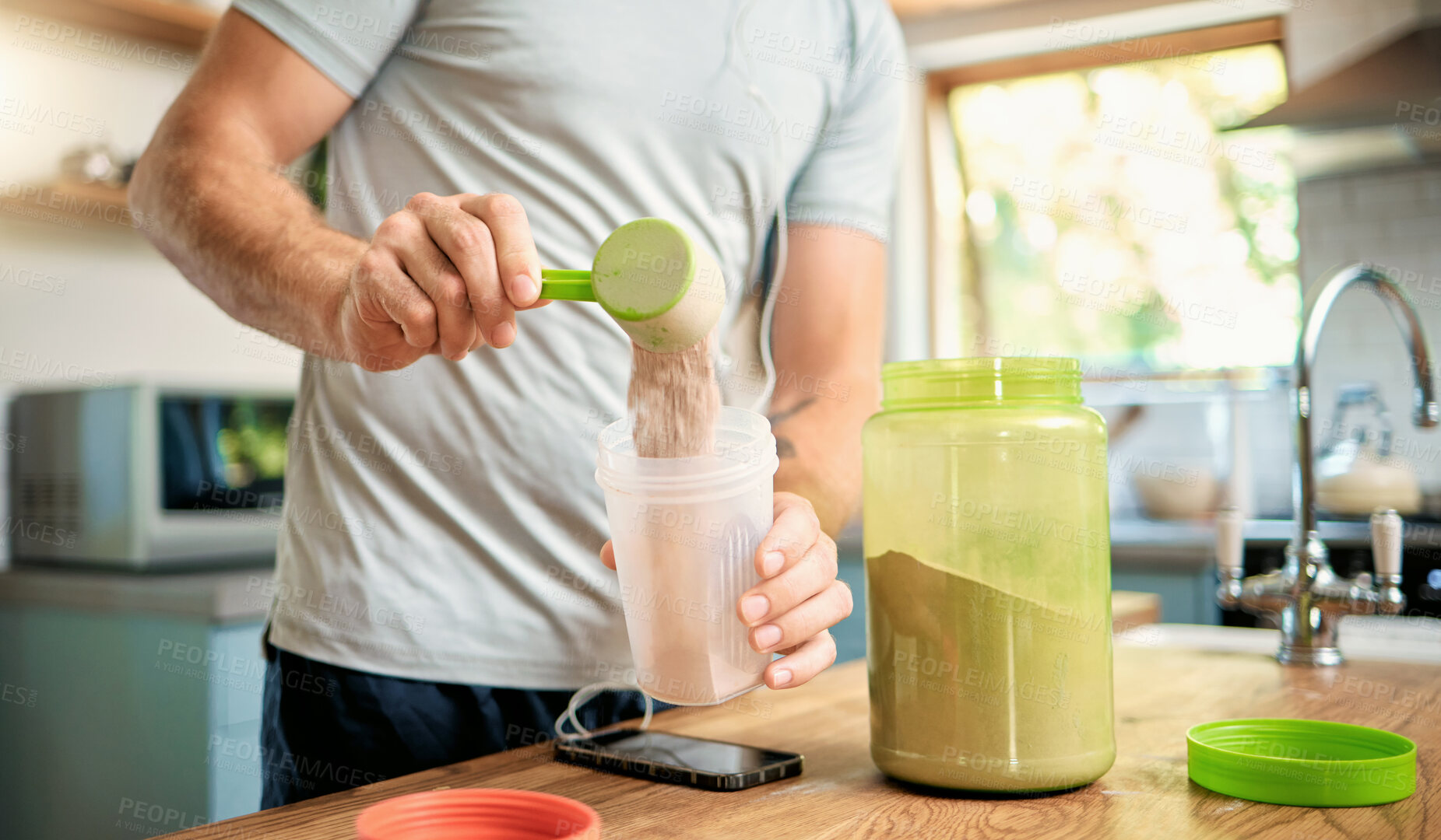 Buy stock photo Hands, man and bottle with protein shake at house for fitness, nutrition and muscle growth. Athlete, male person and kitchen with beverage, supplement powder and organic ingredients for weight gain