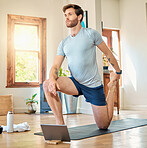 One fit young caucasian man stretching legs with lunge bodyweight exercise and holding foot while training with online tutorial on digital tablet at home. Guy gaining muscle, endurance, balance and core strength during yoga workout