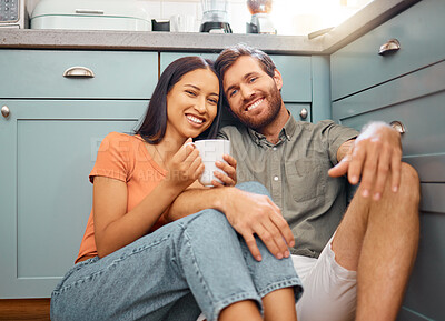 Buy stock photo Couple, happy and portrait with drink in kitchen with bonding, relax and interracial relationship. Love, smile and man with woman on floor for break, commitment and trust with coffee in home
