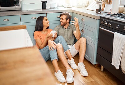 Buy stock photo Couple, happy and conversation with drink in kitchen, bonding and interracial relationship. Connection, talking and man with woman on floor for break, commitment and funny story with coffee in home