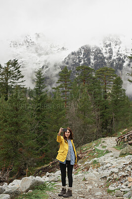 Buy stock photo Mountain, selfie and winter with woman hiking in forest for adventure, journey or wanderlust. Smile, space and  wilderness trees with happy hiker in woods for outdoor hobby, social media or travel