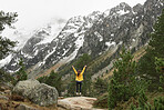 Travel adventure hiker woman celebrates arms outstreched enjoying beautiful nature forest landscape wanderlust