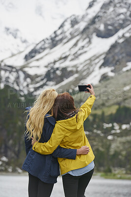 Buy stock photo Mountain, hiking and back of women with selfie for adventure, travel and memory for holiday. Friends, nature and people with picture for social media, post and moment for tourism, explore and outdoor