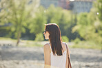 Dreamy Portrait of beautiful woman in sunlight flare exploring travel destination on vacation
