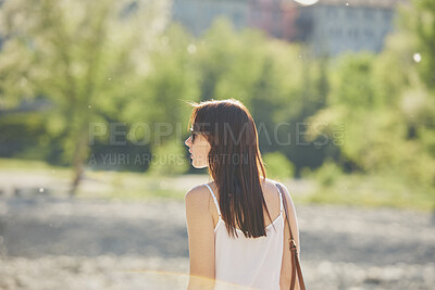 Buy stock photo Woman, tourist and sightseeing with sunglasses in nature for outdoor vacation or summer holiday. Profile, female person or traveler walking with sunshine in garden or park for travel or destination