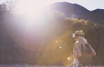 Adventure woman wearing vr headset augmented virtual reality in beautiful outdoor landscape concept sunset flare