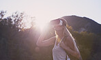 Adventure woman wearing vr headset augmented virtual reality in beautiful outdoor landscape concept sunset flare