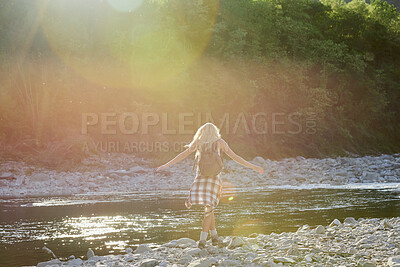 Buy stock photo Woman, tourist and lake with backpack in nature for outdoor freedom, vacation or summer holiday. Back view, female person or traveler with open arms on river coast for travel, trip or destination
