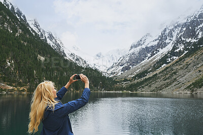 Buy stock photo Woman, lake and hiking with phone for photography, social media post or travel blog. Space, person and mobile for profile picture update, trekking scenery and river with mountain view in wilderness