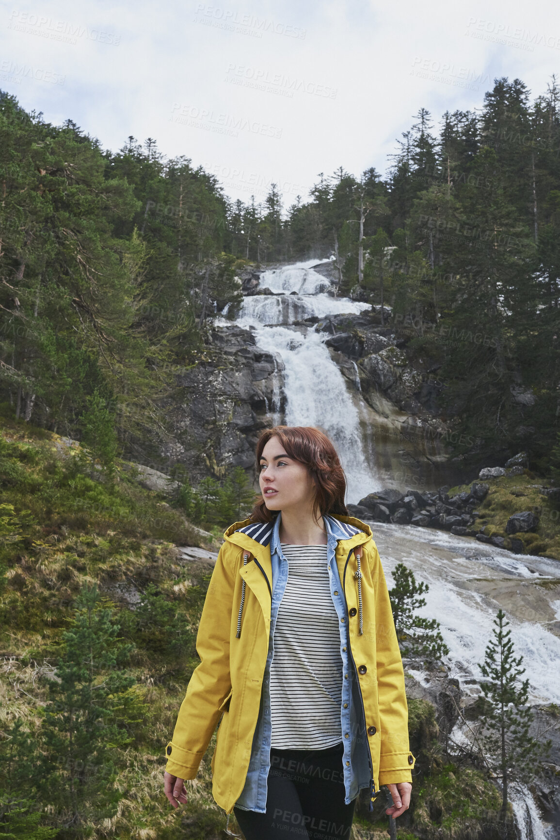 Buy stock photo Woman, hiking or sightseeing in nature with waterfall, exploration or outdoor adventure for winter trip. Female person, thinking and peace in forest with scenic view, cold climate or travel vacation.