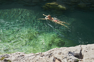 Buy stock photo Swimming, nature and above of woman in river for holiday, vacation and adventure in summer. Travel, weekend and person in water for activity, fun and tourism in lake, natural spring or outdoor