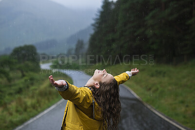 Buy stock photo Happy, woman and arms raised in nature with rain, fresh air and freedom for travel adventure on weekend. Female person, relax and smile outdoor with winter holiday, cold climate and wellness on trip.