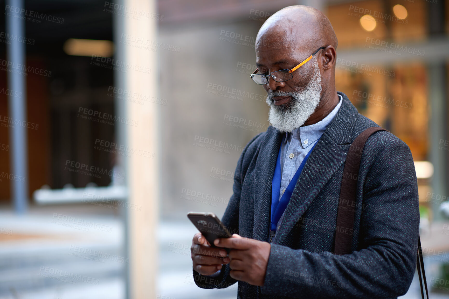 Buy stock photo Businessman, commute and outdoor in city with phone, check schedule and email notification for work. Mature, black person and browsing in urban town with tech, online calendar and travel for job.
