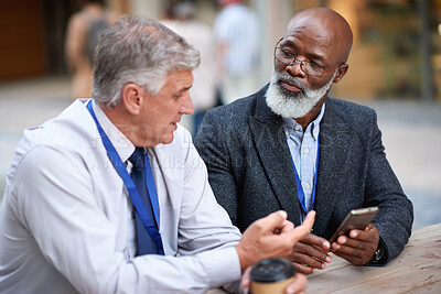 Buy stock photo Outdoor, friends or business people with phone for coffee break, check schedule or project discussion. Connection, mobile and mature men with conversation for deadline update, reading email and city
