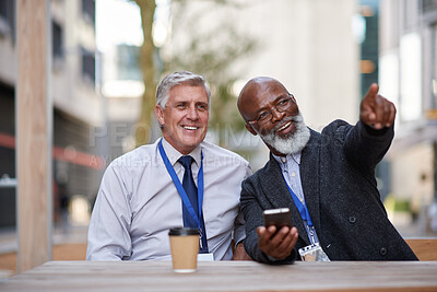 Buy stock photo Phone, pointing and talking with business people in city together for building or property development. App, conversation and planning with mature men outdoor at cafe or restaurant for real estate
