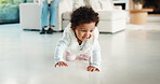 Baby, cute and crawling on floor in living room of home for development, growth or milestone. Excited, happy and smile of infant girl in modern apartment for childhood, improvement or progress