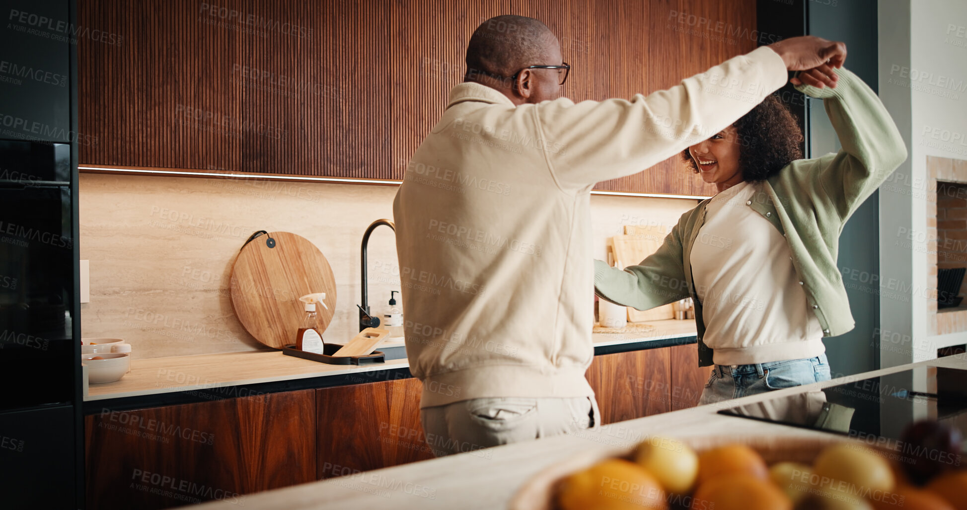 Buy stock photo Father, child and dance in kitchen for love, happiness and family connection with daughter. African dad, girl and holding hands with music, rhythm and bonding together on weekend break in house