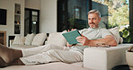Streaming, relax and man on couch with tablet, movie binge and video watching on digital app. Smile, comfy or mature person in house with tech, series subscription or search on entertainment platform