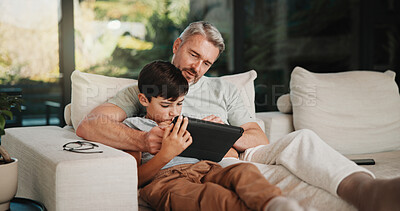 Buy stock photo Father, child and talk in home with tablet, bonding and educational game for cognitive development. Family, dad and son learning on couch with tech, digital app and conversation for online gaming.