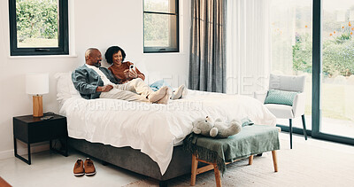Buy stock photo Relax, reading or couple with phone in bed for support, show post or watch video for weekend bonding. Smile, social media and mature African people with mobile in home, website or blog for connection