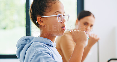 Buy stock photo Bathroom, brushing teeth and girl in glasses with mother for dental hygiene or morning routine. Oral care, support and toothbrush of daughter with single parent woman in apartment for mouth cleaning