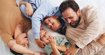 Buy stock photo Love, family and tickle in bedroom, children laugh and bonding together with parents from above. Mother, father and kids with funny game, playful and relax with care in morning for connection at home