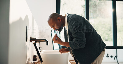 Buy stock photo Morning, man and brushing teeth in bathroom with hygiene, dental health and routine for wellness. Mature, black person and toothbrush in home with oral care, habits and clean mouth for fresh breath.