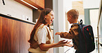 Mom, boy and motivation with backpack in kitchen with support, happy and back to school in home. People, mother and child with smile, excited or ready for learning with bag in morning at family house