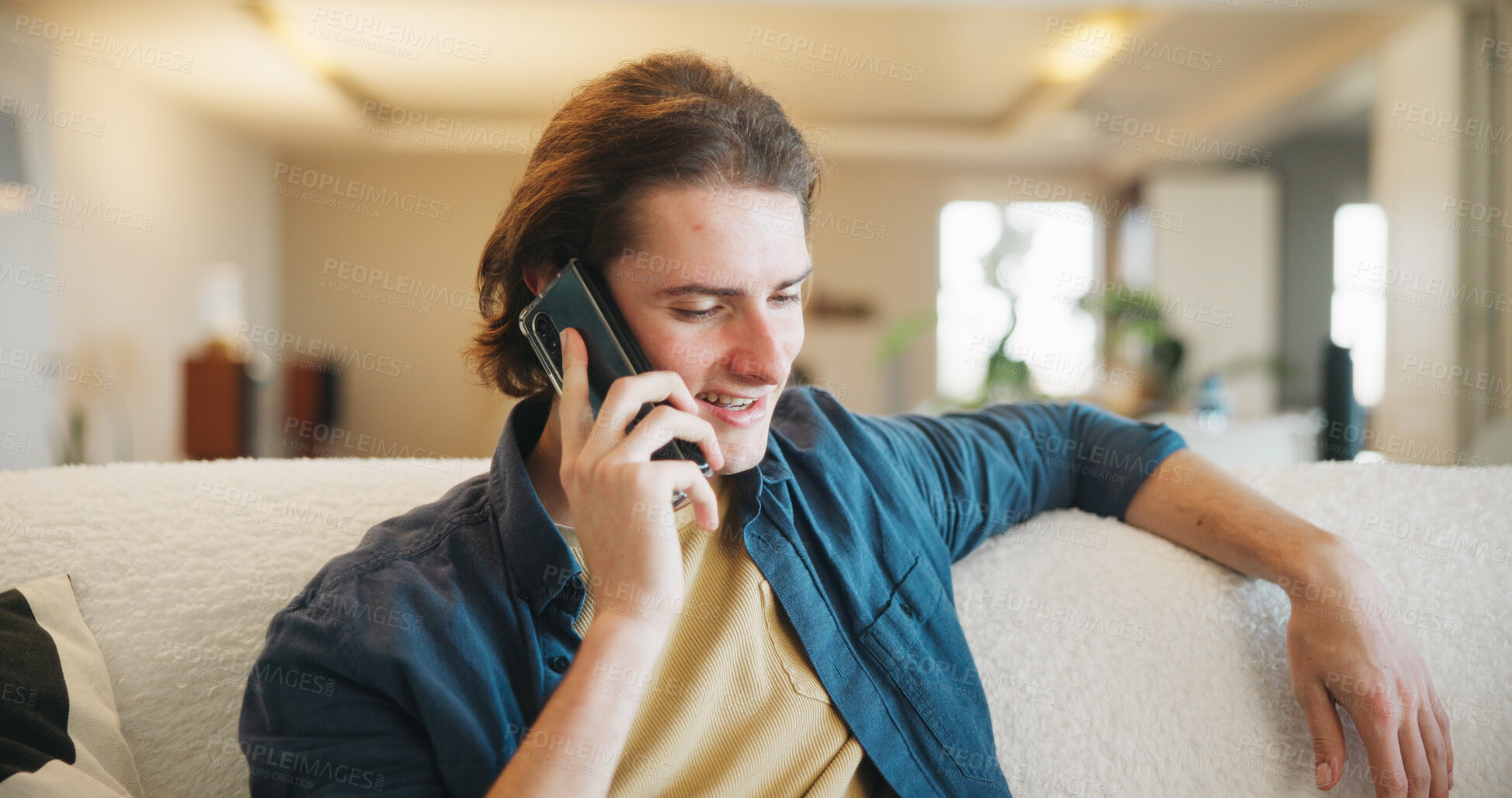 Buy stock photo Happy, man and talking with phone call on sofa for friendly discussion, weekend update and relax. Smile, person and mobile chat in living room for social networking, conversation and catch up in home