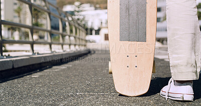Buy stock photo Behind, legs and skateboard with person in city for eco friendly commute or travel on bridge. Asphalt road, sneakers and transportation with man skating outdoor in urban town for sports hobby
