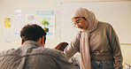 Student, teacher or muslim woman in classroom with help, education or advice for biology assignment. Islamic person, educator and teaching in high school with tips, assistance or life science project