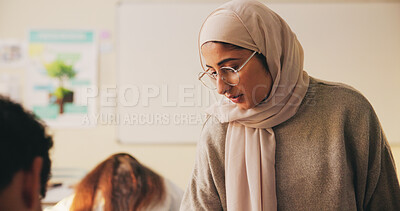 Buy stock photo Teacher, muslim woman and students in class for education, test supervision and academic support. Teaching, study and islamic educator at high school for learning guidance, assistance or monitor exam