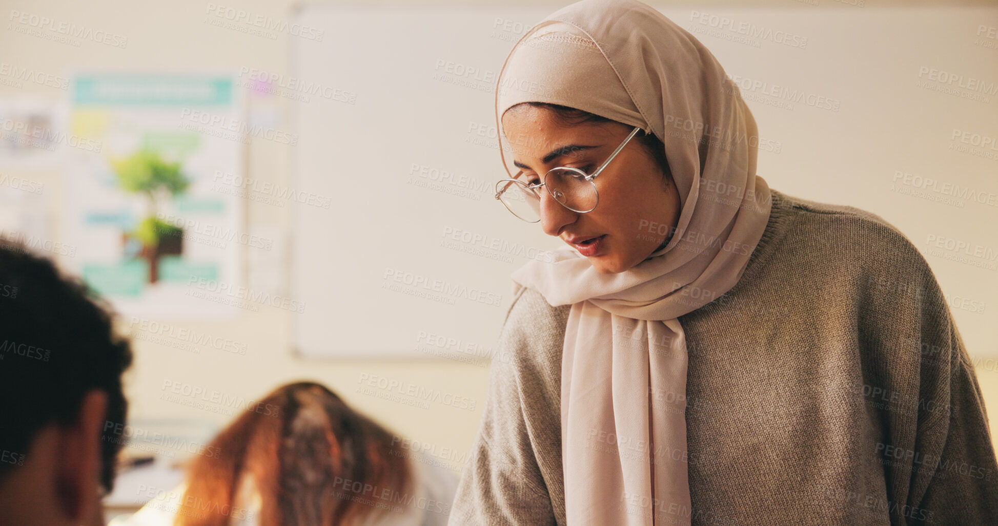 Buy stock photo Teacher, muslim woman and students in class for education, test supervision and academic support. Teaching, study and islamic educator at high school for learning guidance, assistance or monitor exam