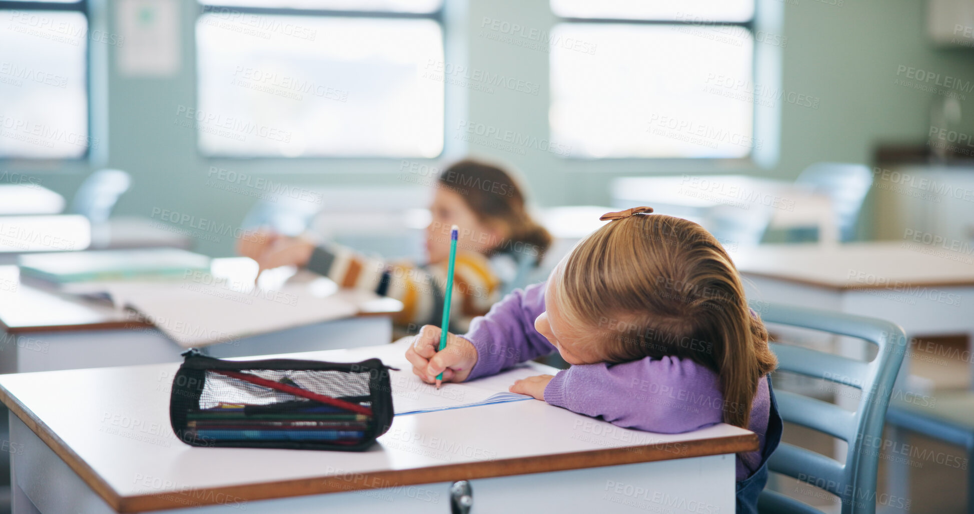 Buy stock photo Education, student and writing with girl child at desk in classroom for assignment or development. Learning, notes and study with kid at academy for academic growth, curriculum knowledge or syllabus