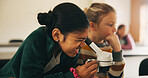 Classroom, students and girl with microscope for learning, stem education and science lesson. Knowledge, smart and kid with tech equipment for biology project, analysis and test experiment in school