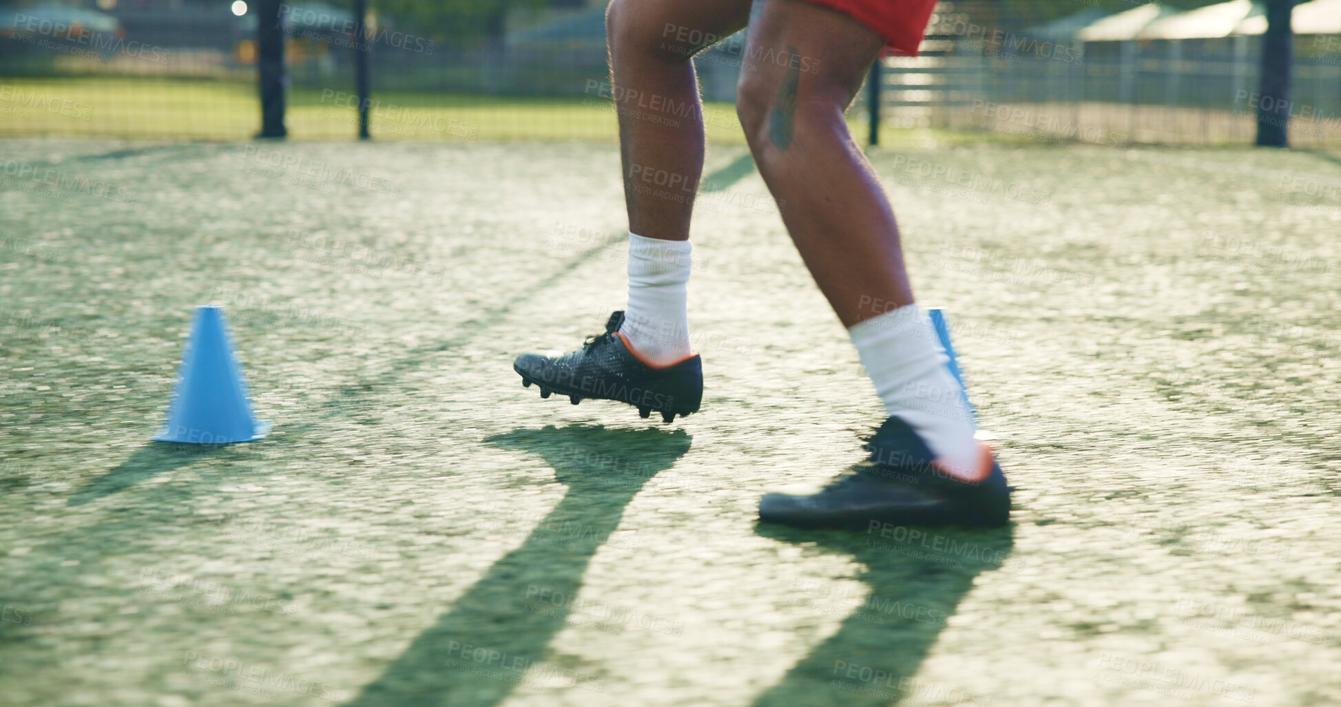 Buy stock photo Legs, soccer and person with cone for sports, game practice and running drills for training. Football player, feet and man with equipment on field for agile exercise, fitness challenge and outdoor