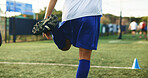 Legs, soccer and warm up with man on field for competition, game or sports preparation. Balance, fitness and stretching with footballer player on grass pitch for start of practice or training